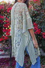 Load image into Gallery viewer, Woman wearing a light green lace kimono in a garden with pink flowers