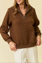 Load image into Gallery viewer, Woman wearing a brown cable knit sweater against a beige background