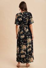 Load image into Gallery viewer, Woman wearing a floral dress with a beige background