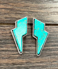 Load image into Gallery viewer, Turquoise lightning bolt earrings on a wooden surface
