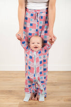 Load image into Gallery viewer, Baby in a matching red, white, and blue checkered outfit with a person holding their hands.