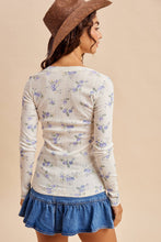 Load image into Gallery viewer, Woman wearing a floral long-sleeve top and denim skirt on a beige background
