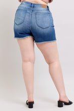 Load image into Gallery viewer, Person wearing blue denim shorts on a plain background