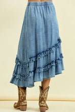 Load image into Gallery viewer, Blue denim skirt with ruffles worn with brown boots on a beige background
