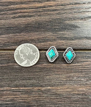 Load image into Gallery viewer, Two turquoise stone earrings on a wooden surface with a quarter for scale.