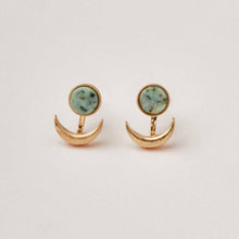 Load image into Gallery viewer, Gold earrings with green gemstones on a light gray background