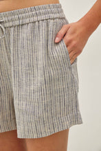 Load image into Gallery viewer, Close-up of striped shorts worn by a person on a plain background