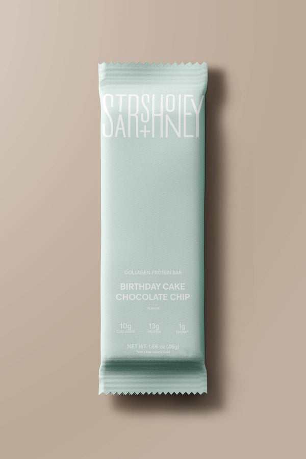 Mint green protein bar with 'Satisfy' branding on a beige background