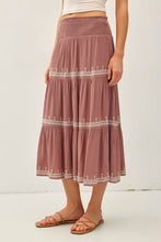 Load image into Gallery viewer, Woman wearing a long, patterned skirt with a white background