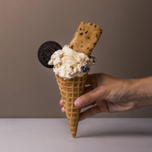 Load image into Gallery viewer, Ice cream cone with cookies held by a hand against a neutral background