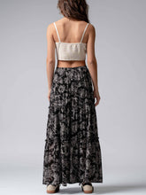 Load image into Gallery viewer, Woman wearing a beige crop top and black patterned skirt on a gray background