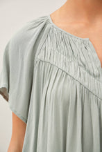 Load image into Gallery viewer, Light green dress with a textured fabric on a plain background