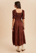 Load image into Gallery viewer, Woman wearing a brown dress with puffed sleeves on a beige background