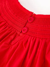Load image into Gallery viewer, Close-up of a red dress with buttons on a white background