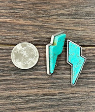 Load image into Gallery viewer, Turquoise lightning bolt earrings on a wooden surface with a quarter for scale.