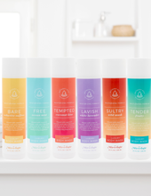Load image into Gallery viewer, Set of colorful body wash bottles with labels on a white shelf.