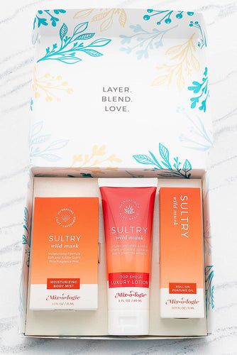 Three skincare products in a box with floral packaging on a white background