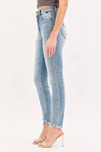 Load image into Gallery viewer, Light blue jeans worn by a person on a white background