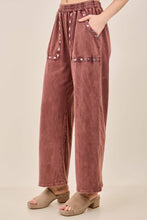 Load image into Gallery viewer, Pink pants with decorative buttons on a beige background