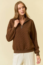 Load image into Gallery viewer, Woman wearing a brown quilted sweater against a beige background