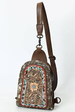 Load image into Gallery viewer, Brown leather sling bag with intricate patterns on a white background