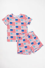 Load image into Gallery viewer, Children's pajama set with red, white, and blue pattern on a white background