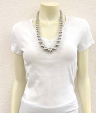 Load image into Gallery viewer, White t-shirt with a necklace on a mannequin against a plain background