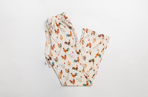 Folded pajama pants with chicken pattern on a white background