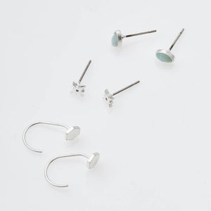 Set of silver earrings on a white background