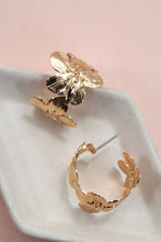 Load image into Gallery viewer, Gold floral earrings on a white dish with a pink background