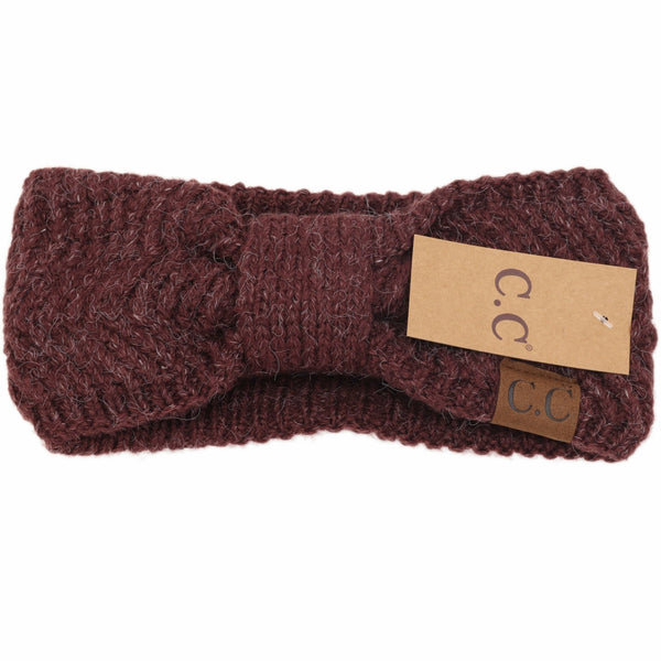 Brown knitted headband with a brand tag on a white background