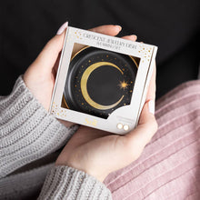 Load image into Gallery viewer, Person holding a box of a crescent jewelry dish against a dark background