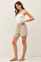 Load image into Gallery viewer, Woman wearing a white tank top and plaid shorts on a plain background