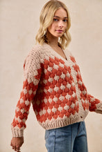 Load image into Gallery viewer, Woman wearing a red and beige patterned sweater against a beige background