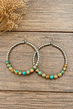 Load image into Gallery viewer, Hoop earrings with beaded detailing on a wooden surface