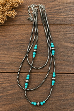 Load image into Gallery viewer, Necklace with turquoise and silver beads on a wooden surface