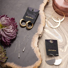 Load image into Gallery viewer, Gold and silver earrings on a wooden surface with &#39;Scout&#39; branded cards.