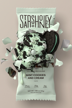Load image into Gallery viewer, Protein bar packaging with mint cookies and cream flavor on a beige background