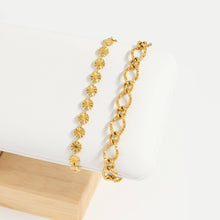 Load image into Gallery viewer, Gold bracelet with floral and chain designs on a white surface