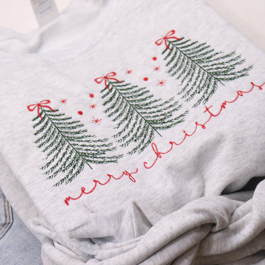Gray sweatshirt with Christmas tree design and 'Merry Christmas' text on a light background