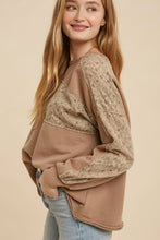 Load image into Gallery viewer, Woman wearing a brown sweater with lace details on a beige background