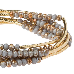 Beaded bracelet with gold accents on a white background