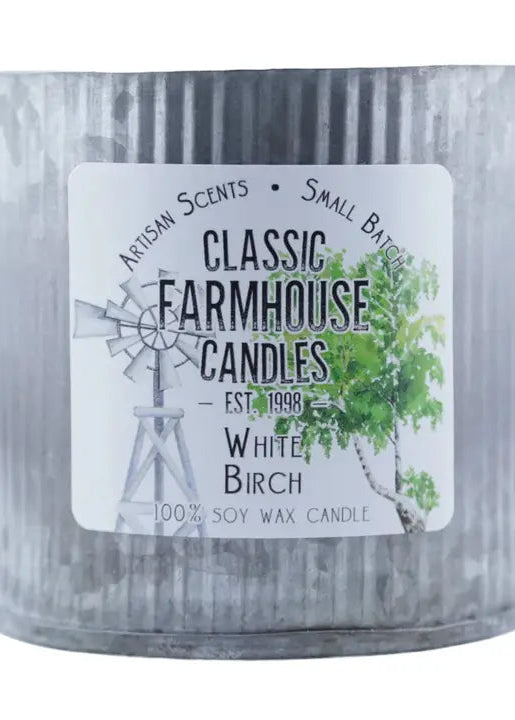 Candle in a metal container with a label on a white background