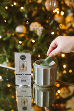 Load image into Gallery viewer, Hand using a diffuser with a Christmas tree in the background