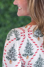 Load image into Gallery viewer, woman with brown hair wearing long sleeve christmas top with trees
