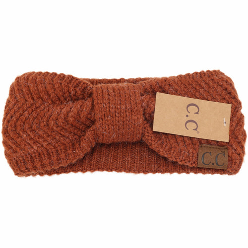 Brown knitted headband with a visible brand tag on a white background