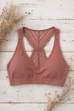 Load image into Gallery viewer, Brown lace bralette on a wooden surface with dried flowers.