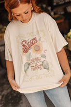 Load image into Gallery viewer, Person wearing a graphic t-shirt with a sunflower design and text.