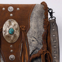Load image into Gallery viewer, Close-up of a brown leather bag with decorative elements on a white background
