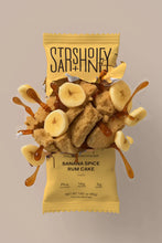 Load image into Gallery viewer, Protein bar packaging with banana slices and caramel sauce on a beige background